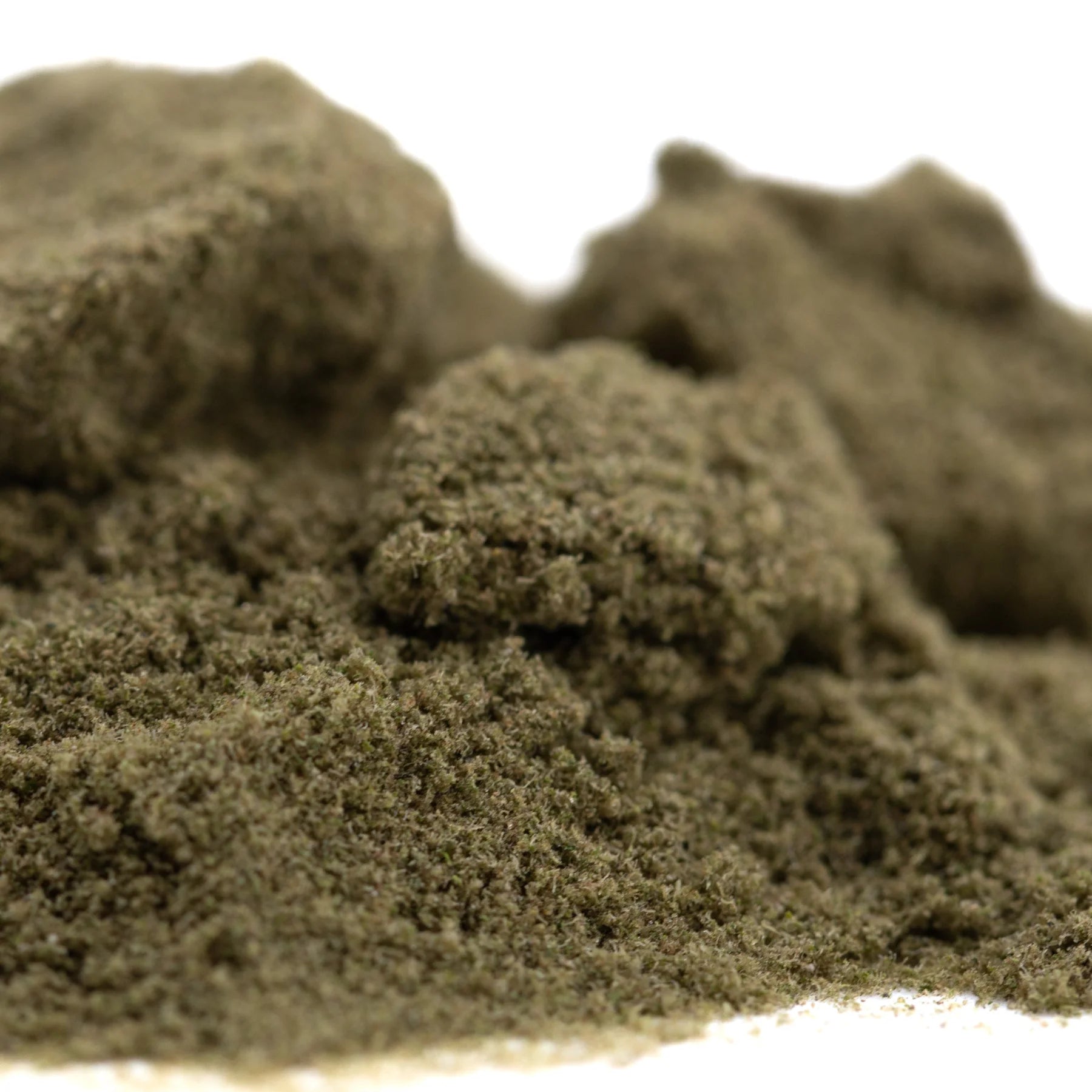 A mound of fine olive-green sour diesel thca kief showcasing industry-leading cbga from the legendary fuel mexican sativa