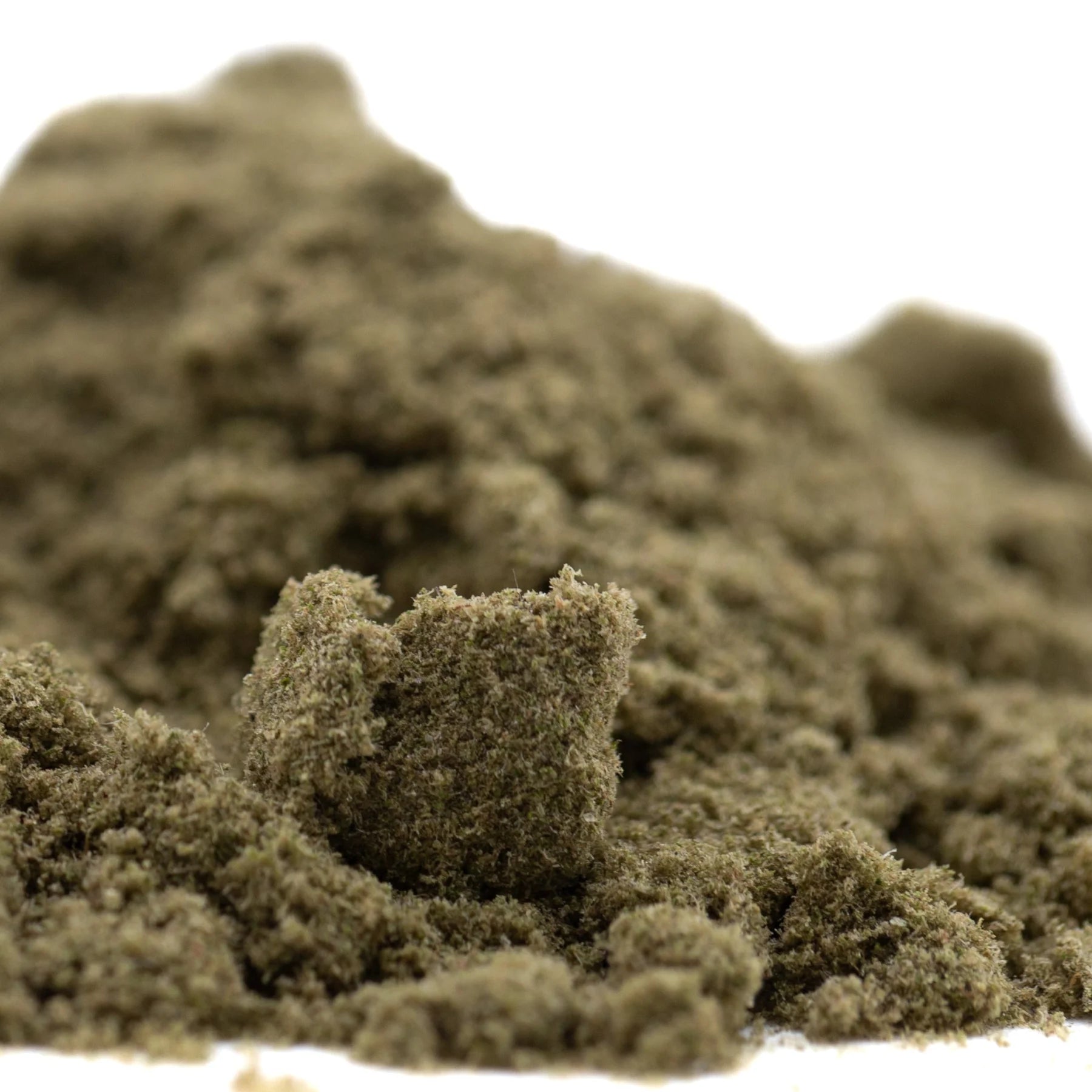 A mound of textured olive green kinetic sand representing sour diesel thca kief full-term wholesale mexican sativa
