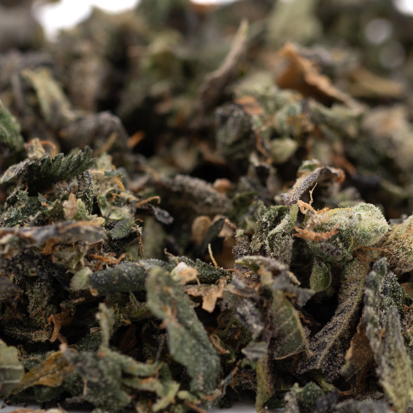 Finely ground dried cannabis flower for Sour Garlic Indoor Trim Wholesale 1LB, ideal for hemp flower and thca trim bulk purchases