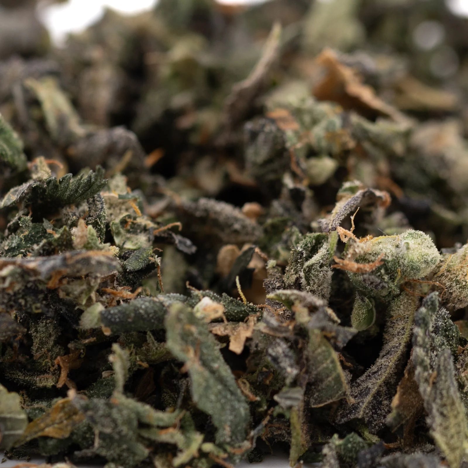 Finely ground dried cannabis flower for Sour Garlic Indoor Trim Wholesale 1LB, ideal for hemp flower and thca trim bulk purchases