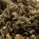 Dense textured sour hawaiian cbd trim hemp flower with green and brown hues covered in fine trichomes