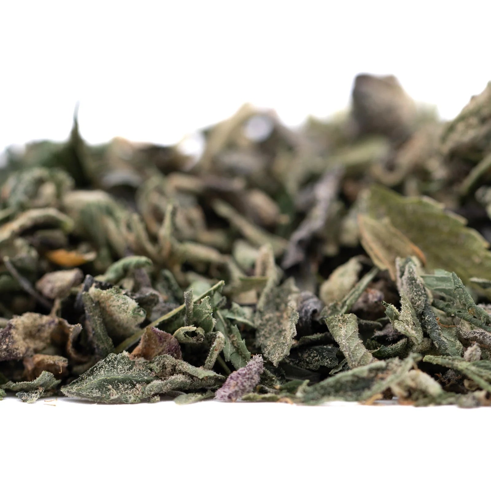 Organic Sour OG THCa trim wholesale with green leaves and dried herbs