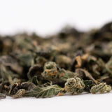 Dried cannabis flower buds and leaves from Sour Runtz Indoor Thca Trim with rich terpene profile