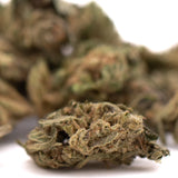 Dense green sour space candy cbd smalls flower with fine trichomes and subtle brown hues for wholesale use