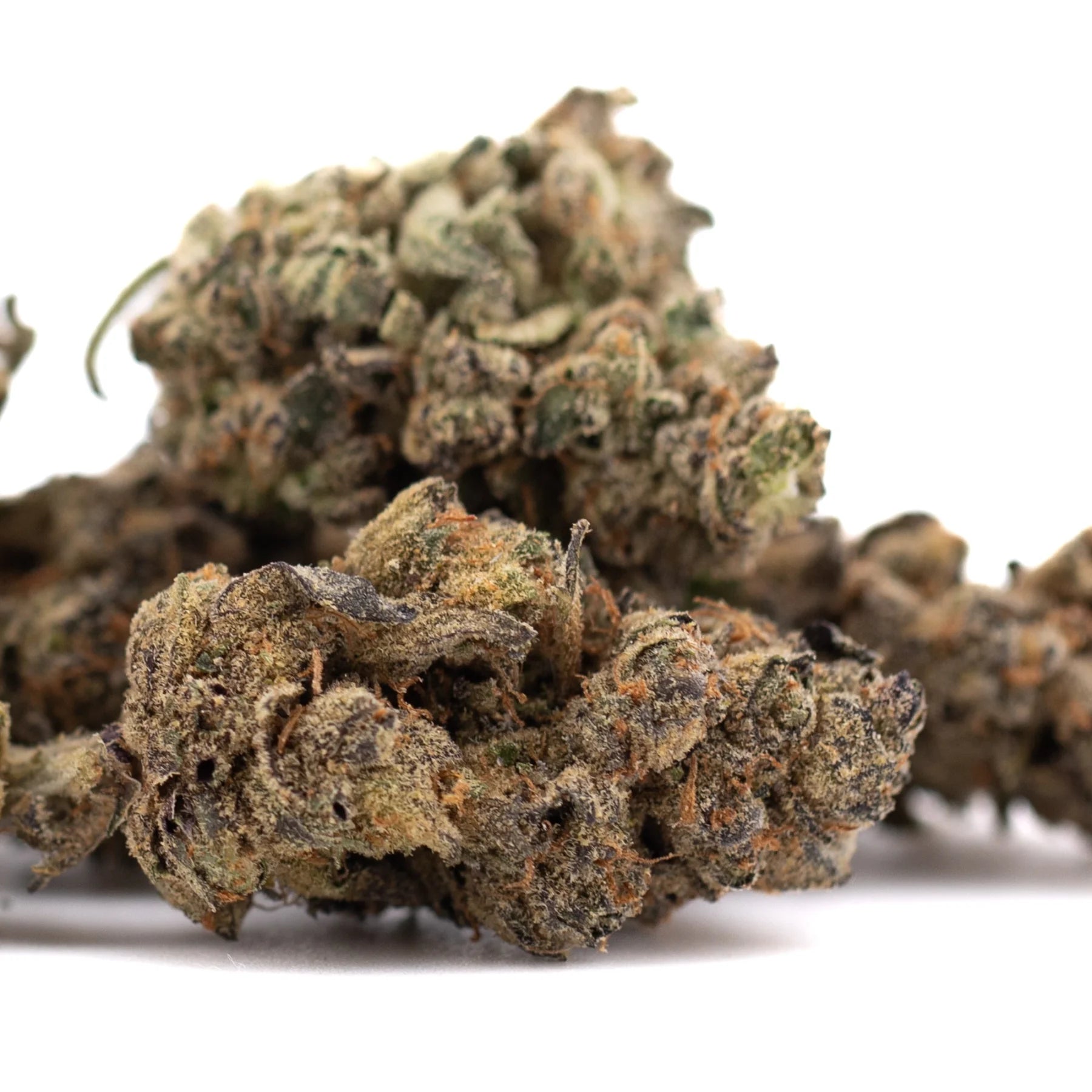 A dense textured space candy indoor thca flower bud with green and brown hues covered in fine trichomes for thca flower wholesale