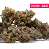 Premium indoor thca flower space candy with dense frosty trichomes and green brown orange hues for thca flower wholesale