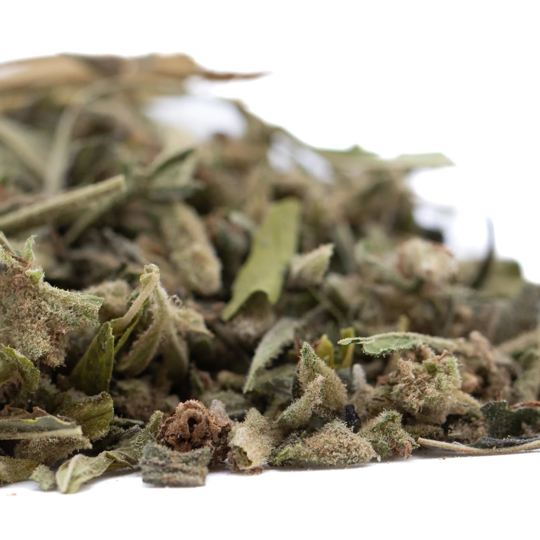 A pile of dried greenish-gray strawberry cheesecake thca trim wholesale with fuzzy texture and small flower buds premium flower