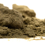 A mound of coarse greenish-brown kief full-term with a granular texture for strawberry cheesecake thca dessert flavor