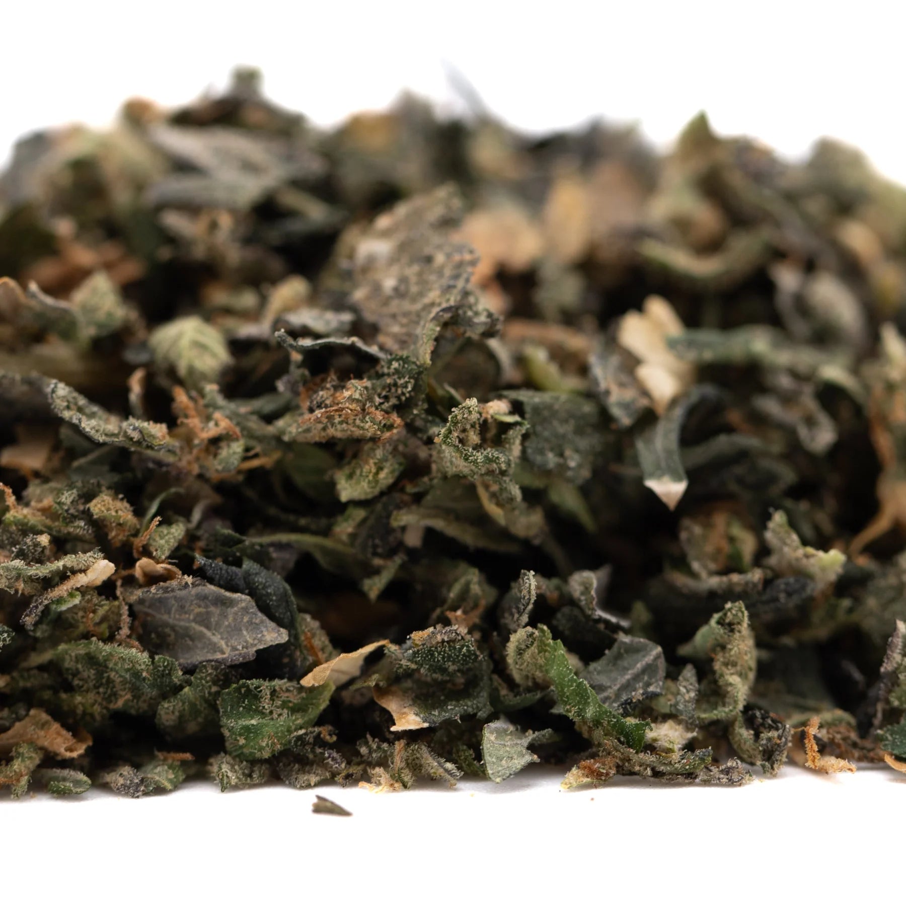 A pile of dried green and brown indoor hemp flower thca trim wholesale from street tarts guava tart strain
