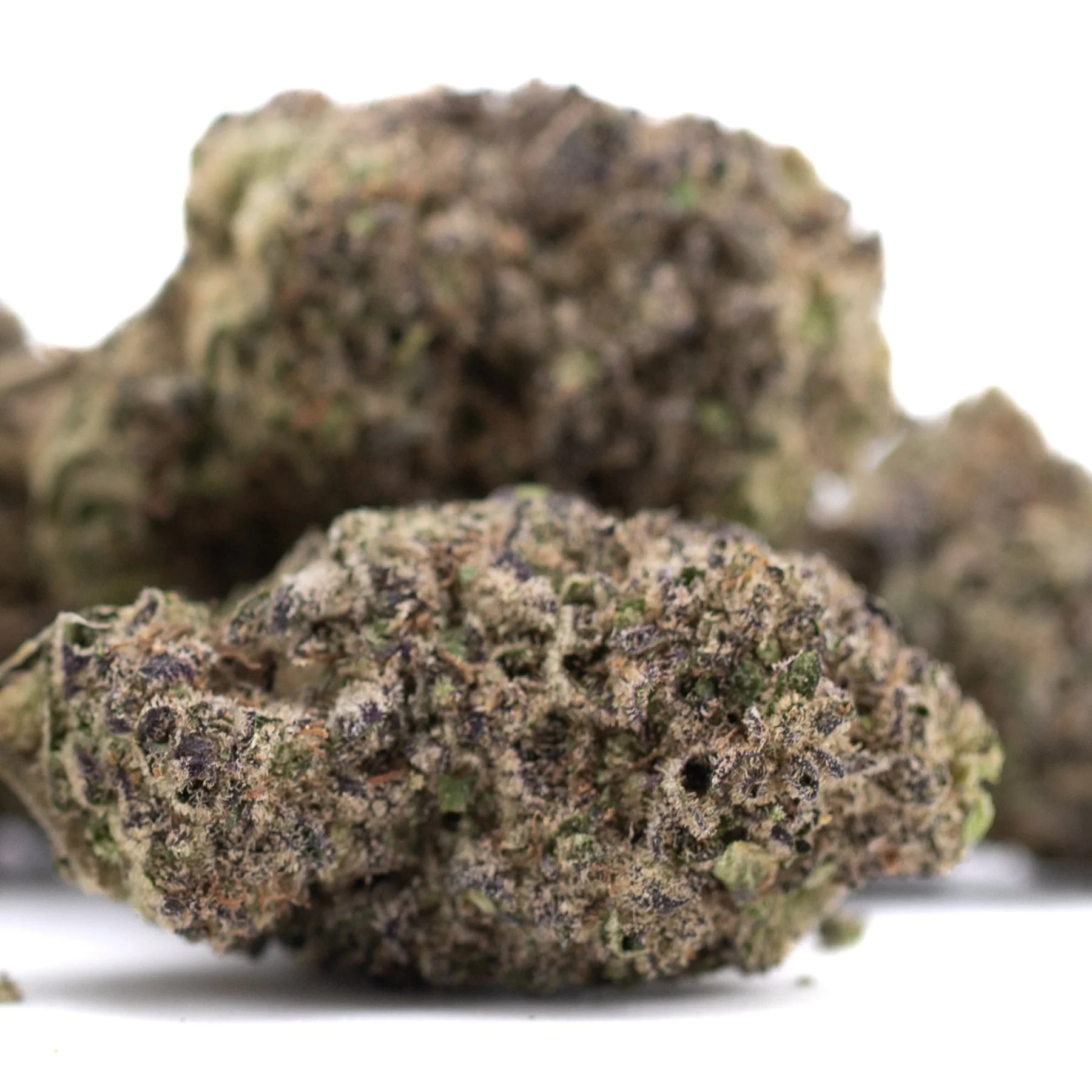 A dense green and brown resinous thca flower hemp flower legendary cinderella in greenhouse wholesale quality