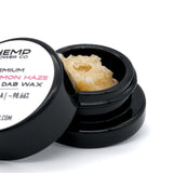 Open container of light yellow Super Lemon Haze THCA Crumble Wax with hemp flower