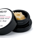 Open container of light yellow Super Lemon Haze THCA Crumble Wax with hemp flower