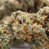 Premium Thai OG’s THCa flower: green orange bud with trichomes