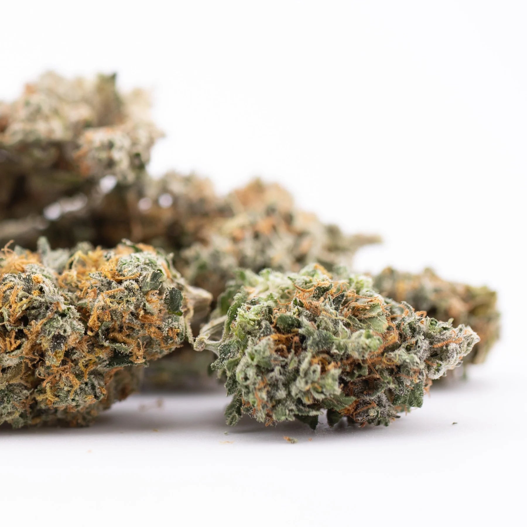 Premium Thai OG THCa hemp flower bud with dense green and orange trichomes