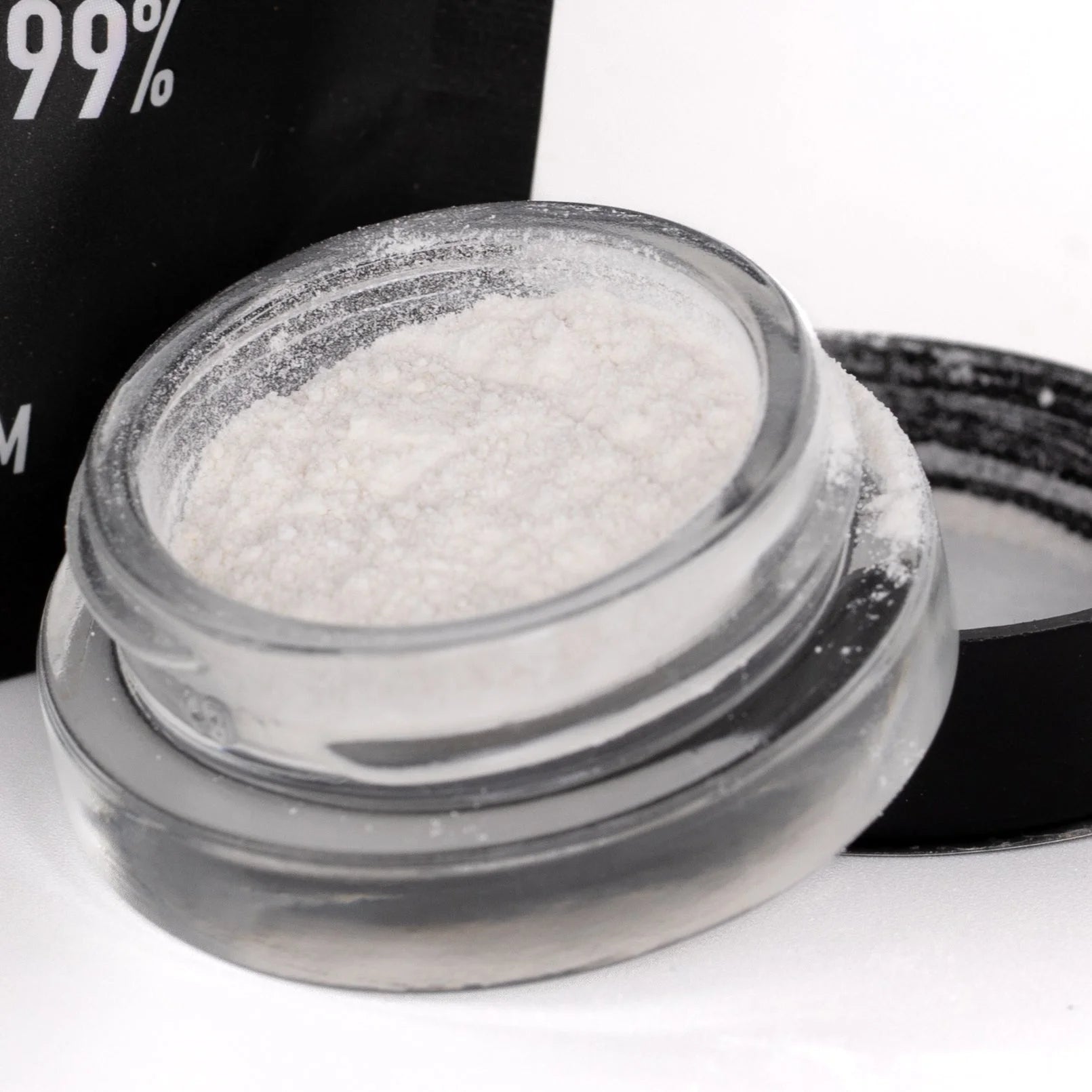 A clear glass jar filled with fine white thca isolate powder from oregon hemp flower for therapeutic benefits
