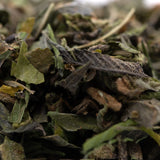 Dried green and brown herbal leaves with fuzzy texture from greenhouse zushi thca shake trim wholesale