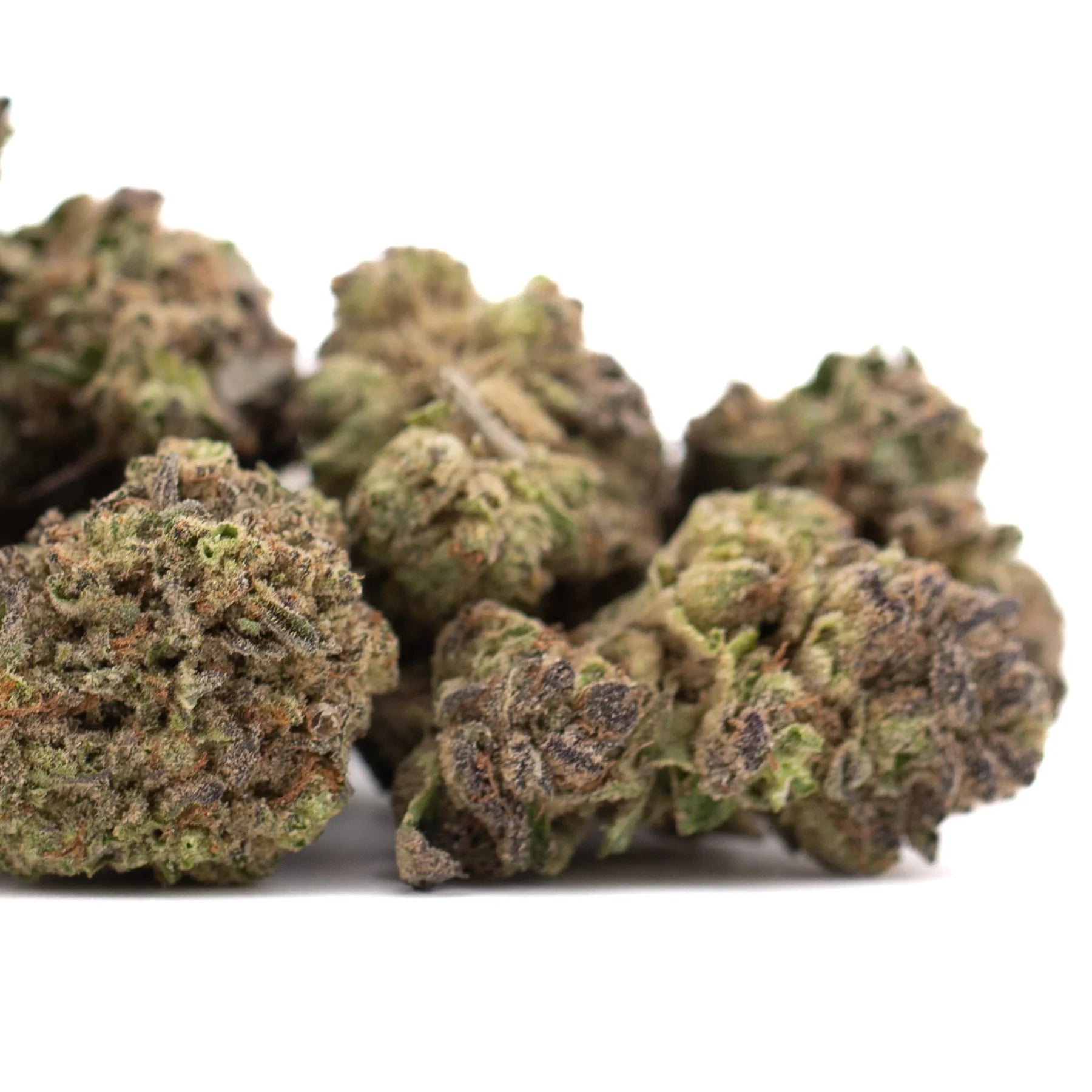 Green and purple-tinged dense frosty cannabis buds of zushi thca hemp flower greenhouse with tropical flavor