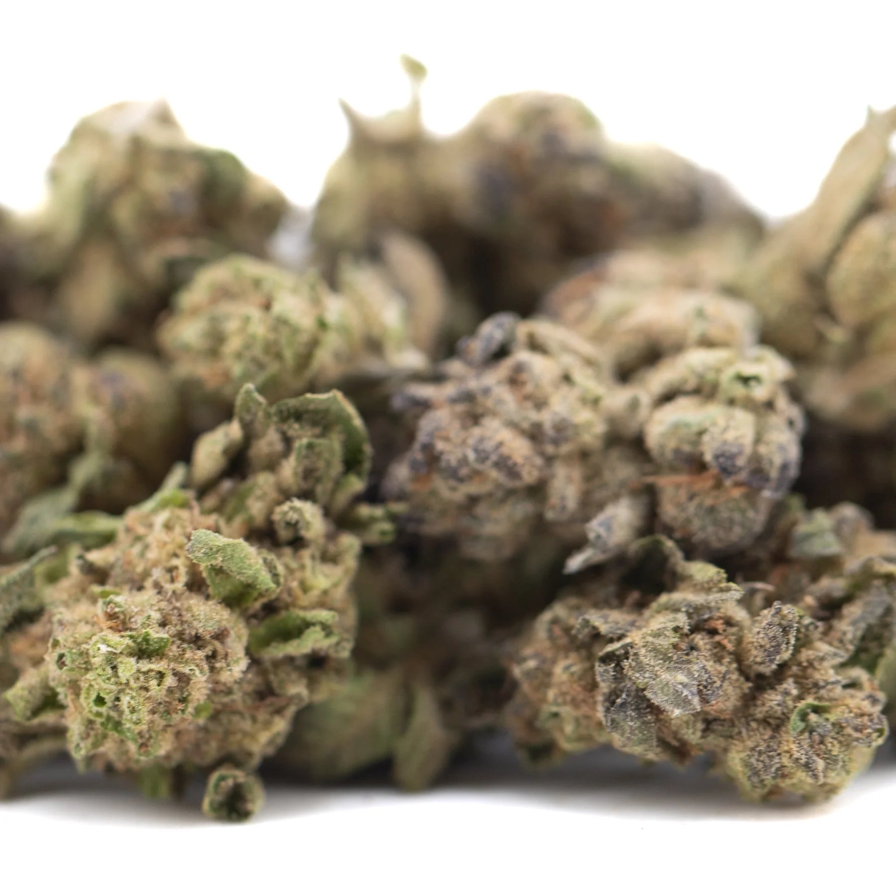 A cluster of zushi thca small hemp flower buds in green, brown, and purple hues with tropical terpene aroma