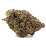 A dense textured zushi thca hemp flower bud with green brown and purple hues grown by greenhouse cultivation